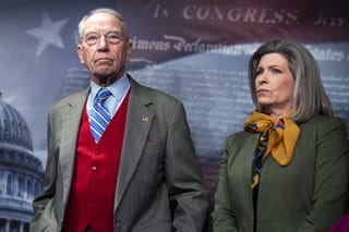 Sens. Chuck Grassley, R-Iowa, and Joni Ernst, R-Iowa, stand in front of a backdrop of the Capitol building.