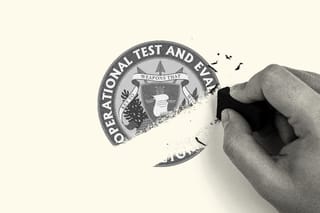 A hand erases the Office of the Director, Operational Test and Evaluation logo