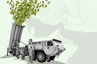 Editorial collage. Three U.S. Army Soldiers check a Terminal High Altitude Area Defense (THAAD) launcher with hundreds of dollar bills shooting out of it. An aerial view of the Strait of Hormuz is visible in the background.