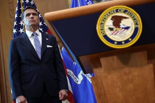 U.S. Attorney General Todd Blanche standing behind a Department of Justice Podium with the seal