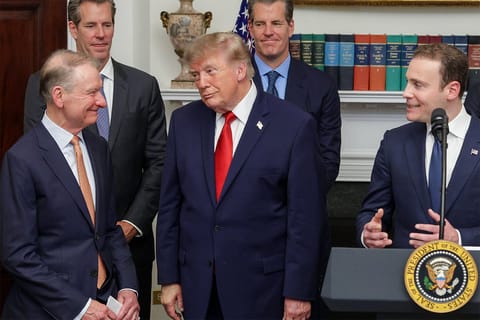 Chairman of the SEC Paul Atkins and U.S. President Donald Trump exchange looks and smiles during a summit of crypto.