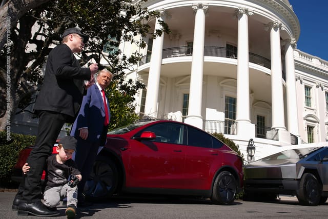 X Æ A-Xii, the son of White House Senior Advisor, Tesla and SpaceX CEO Elon Musk, plays with a toy car as Musk and U.S. President Donald Trump speak alongside a Tesla Model Y and a Cyber Truck on the South Lawn of the White House.
