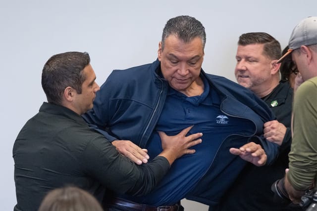 Two agents forcibly remove Sen. Alex Padilla (D-CA) from a press conference held by Homeland Security Secretary Kristi Noem, June 12, 2025.