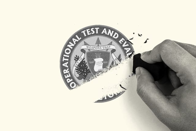 A hand erases the Office of the Director, Operational Test and Evaluation logo