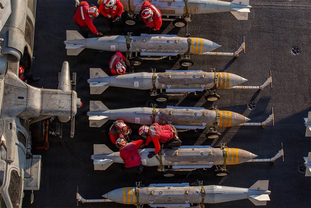 U.S. Sailors prepare to stage ordnance on the flight deck of Nimitz-class aircraft carrier USS Abraham Lincoln (CVN 72) in support of Operation Epic Fury.
