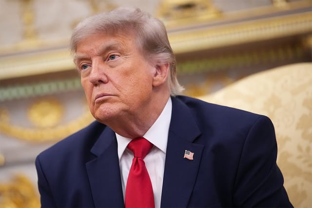 U.S. President Donald Trump sitting in the Oval Office of the White House.