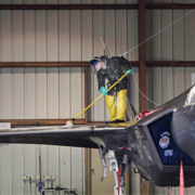 An Airman cleans the top of an F-35A Lightning II.